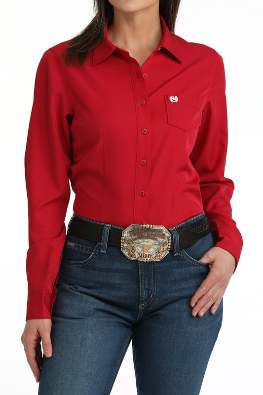 Pink women's cinch shirt worn by a person on a white background