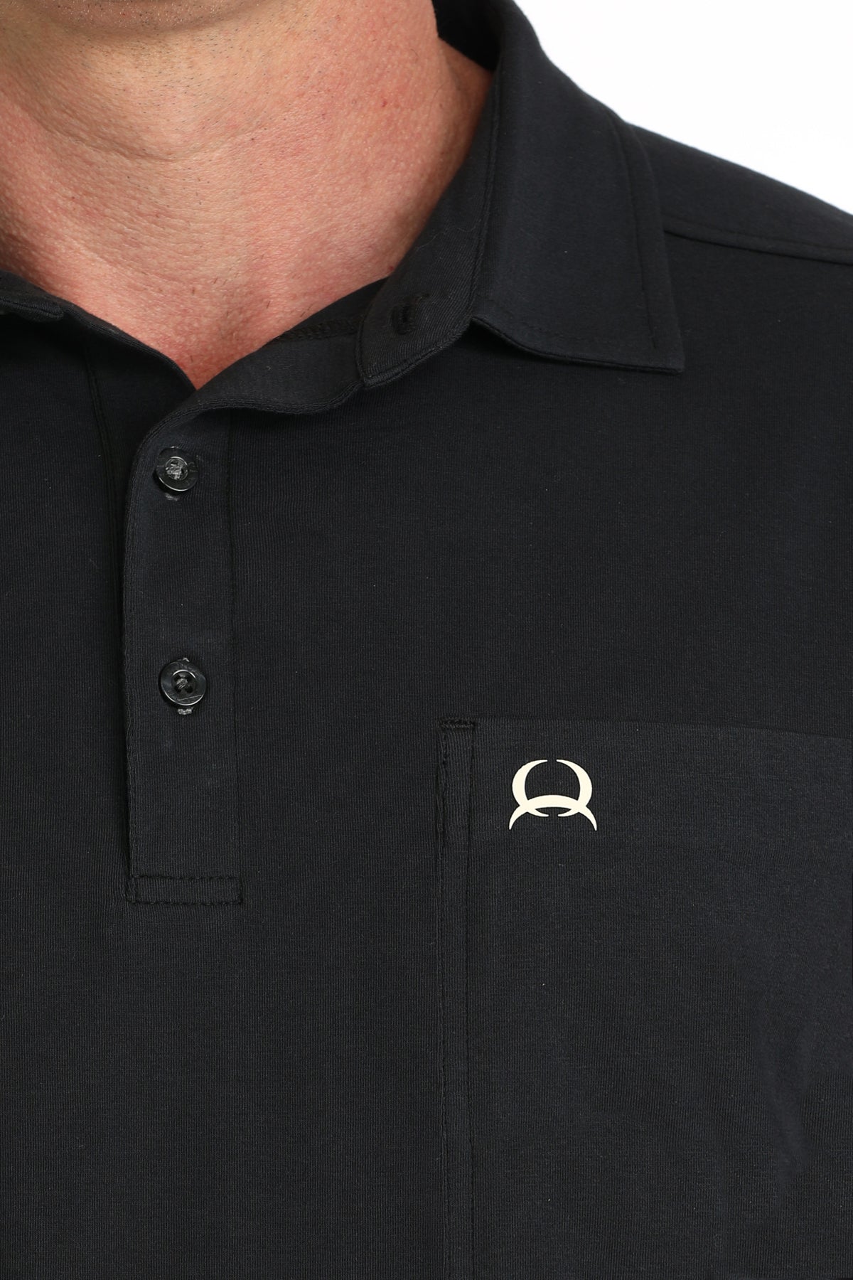 Black polo shirt with a logo on the chest pocket against a white background