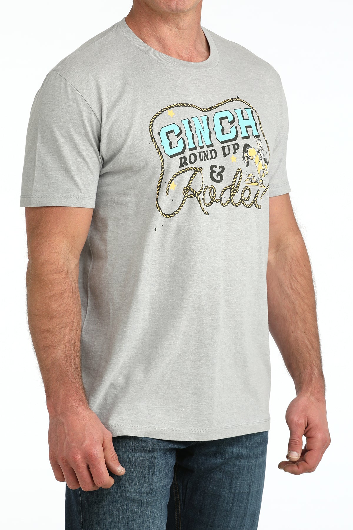 Man wearing a gray Cinch t-shirt with colorful text and graphics on a white background