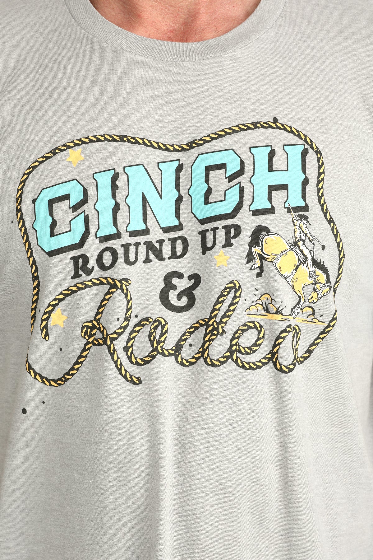 Gray t-shirt with 'Cinch Round Up & Rodeo' graphic design on a plain background