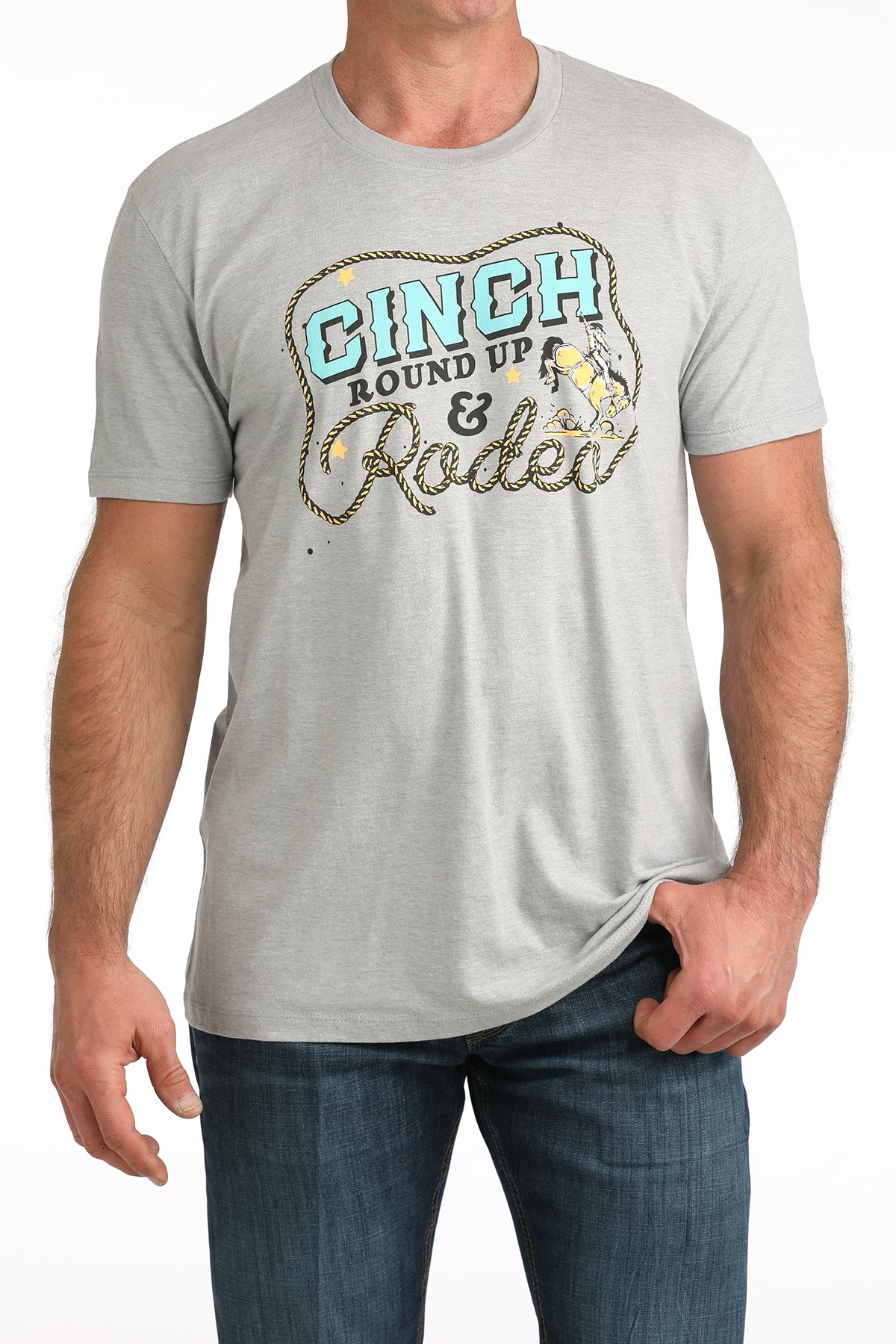 Man wearing a gray Cinch t-shirt with 'Cinch Round Up & Rodeo' graphic design.