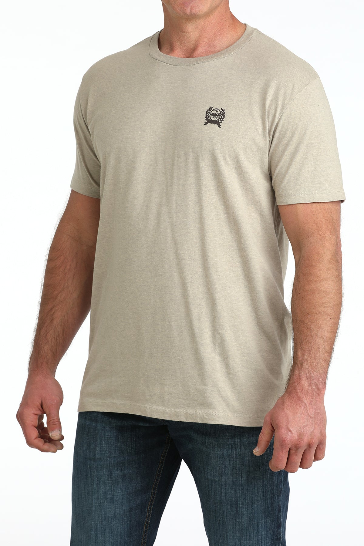 Man wearing a beige Cinch t-shirt with a small logo on a white background