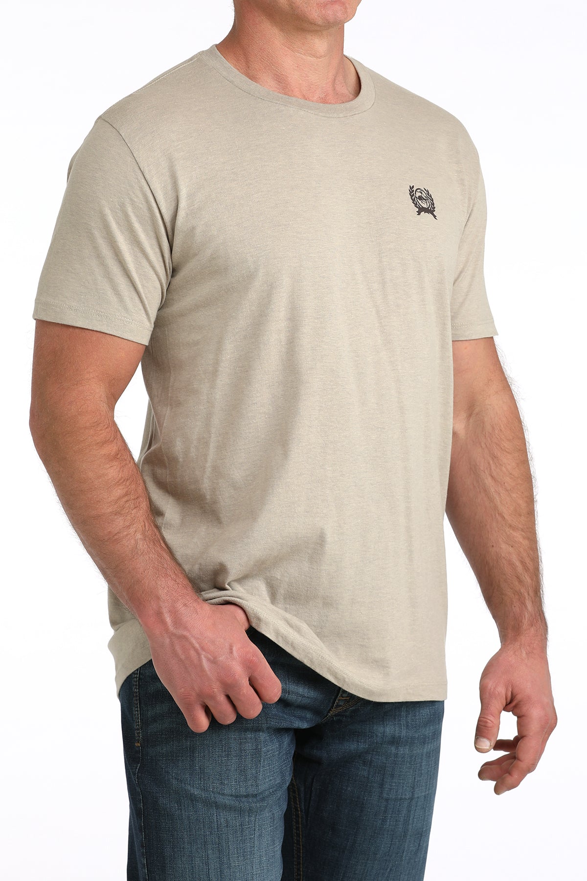 Man wearing a beige Cinch t-shirt with a small logo on a white background
