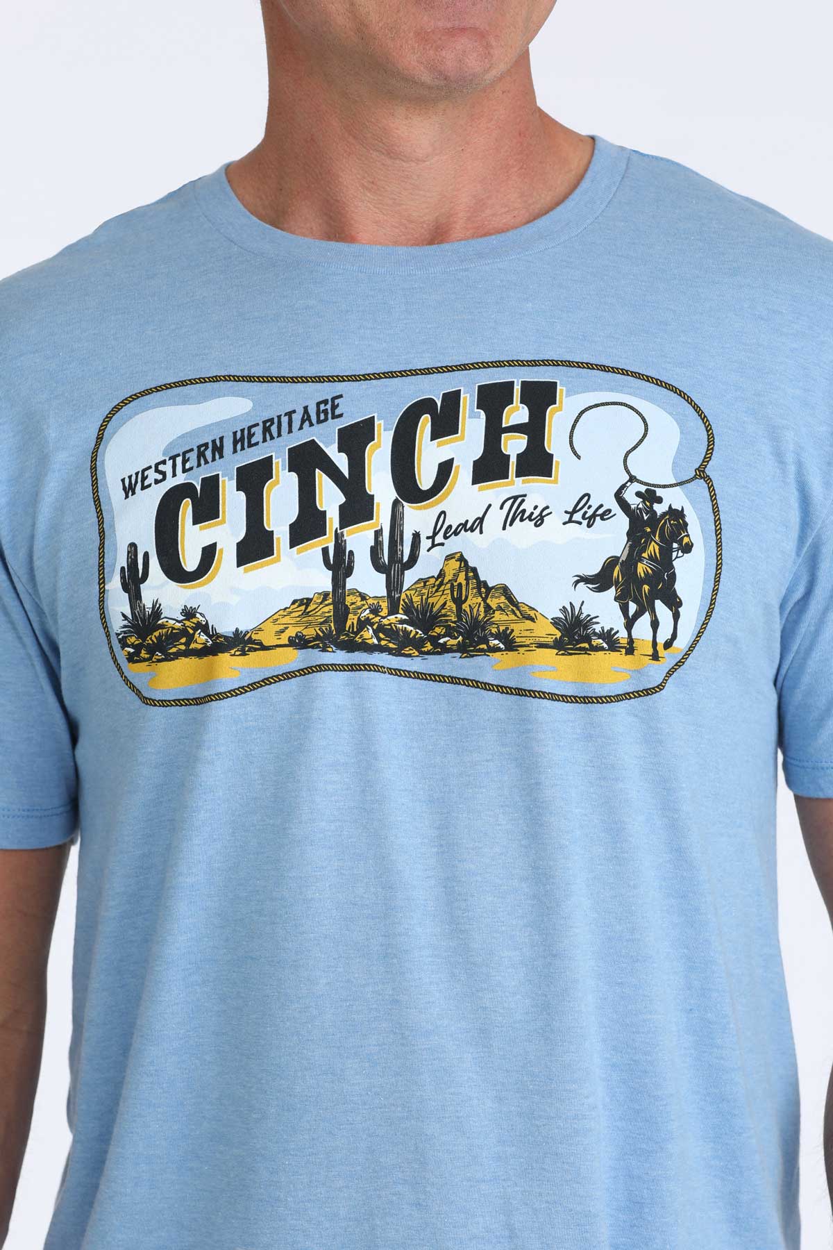 Light blue t-shirt with Cinch logo featuring a desert scene and text.