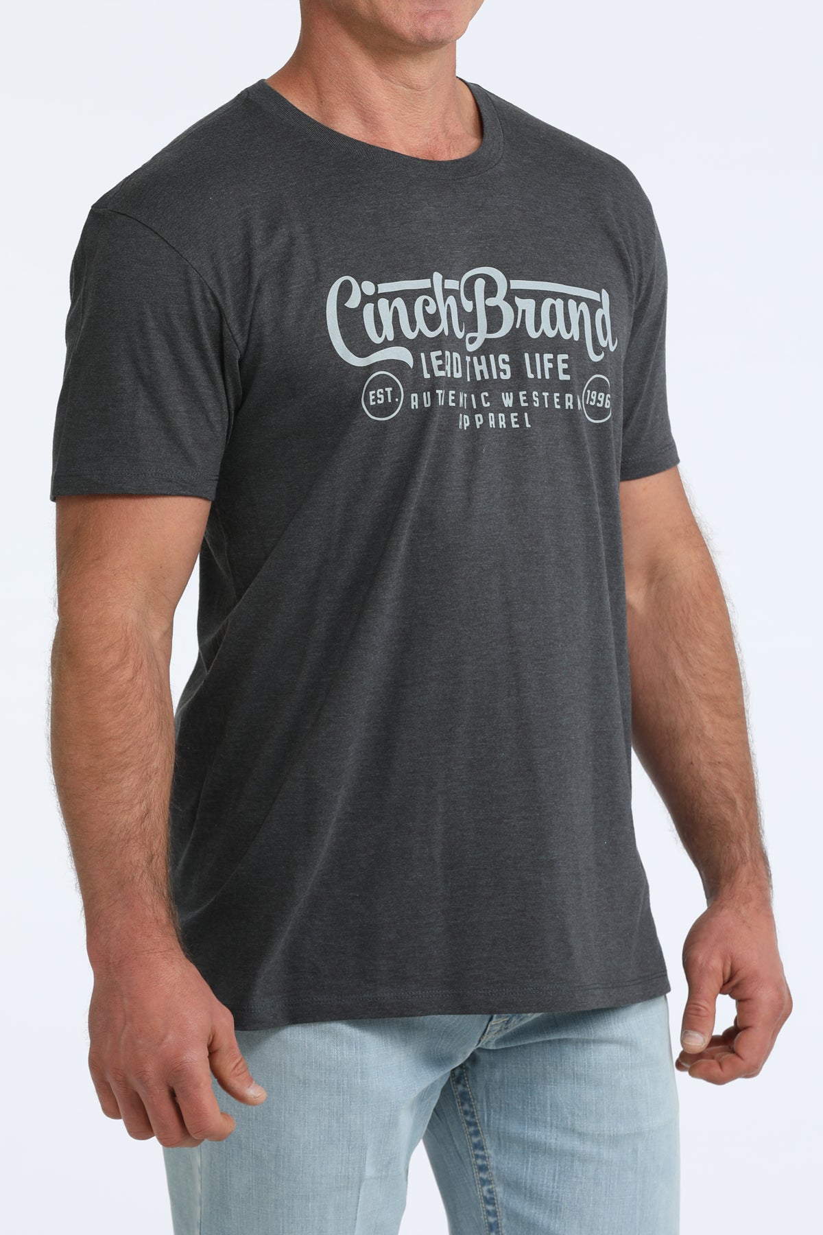 Person wearing a dark gray t-shirt with 'Cinch Brand' logo on a light gray background