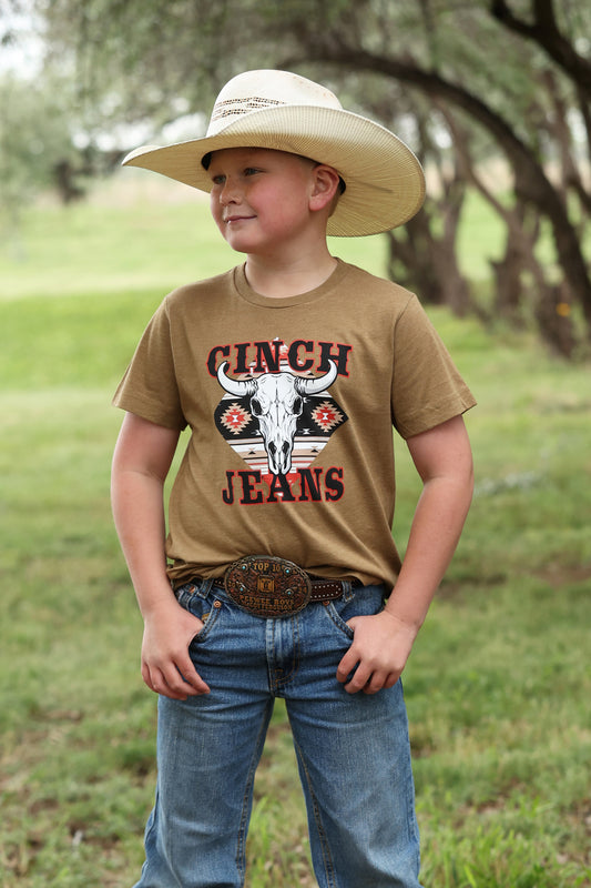 boy wearing a brown Cinch shirt with blue jeans and a cowboy hat