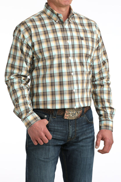 Man wearing a plaid 'Cinch' shirt and jeans on a white background
