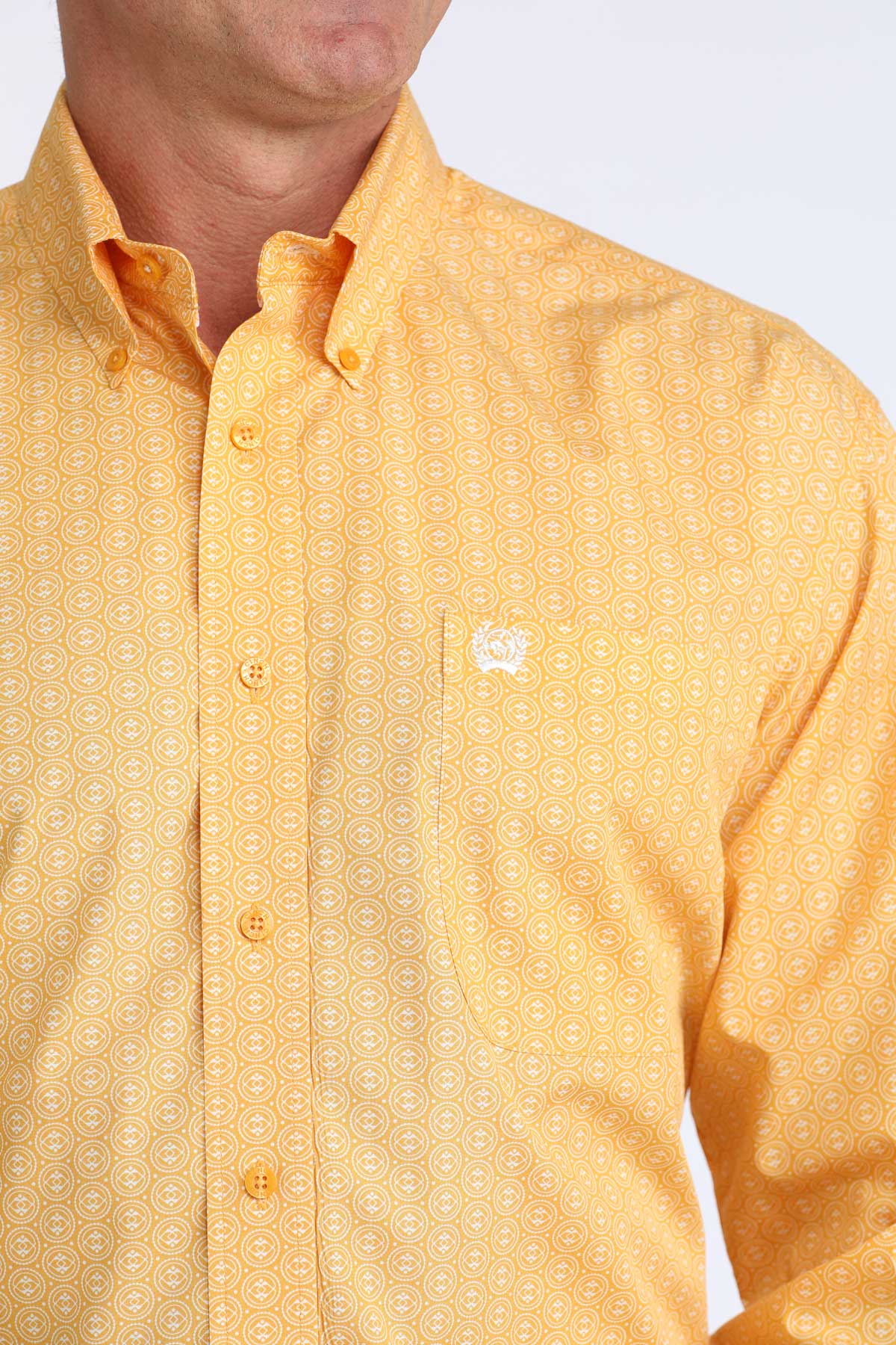 Yellow patterned cinch shirt worn by a man on a light gray background