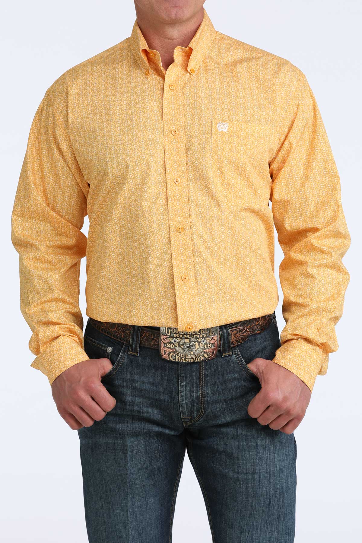 Person wearing a yellow button-up cinch shirt and blue jeans on a white background