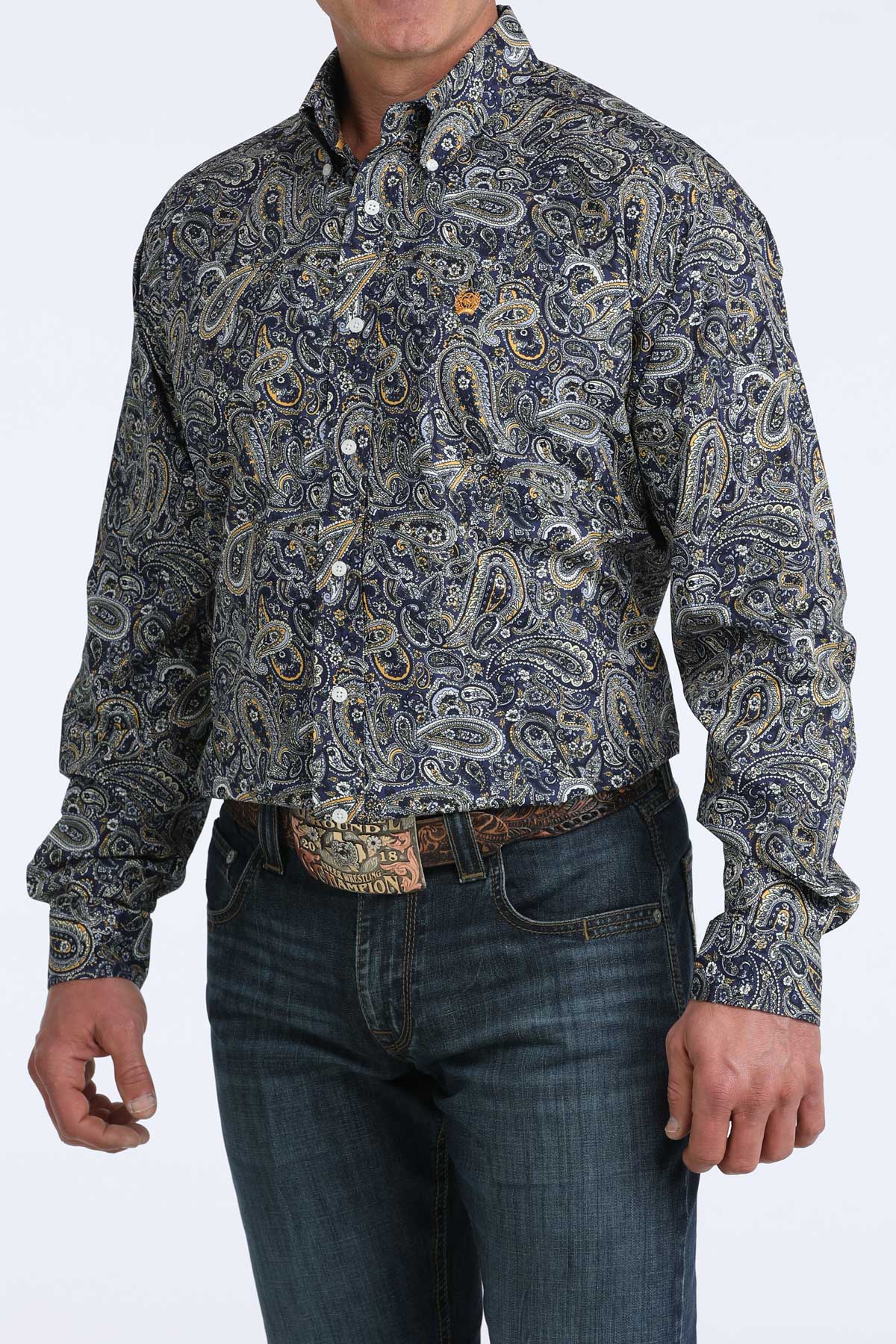 Man wearing a paisley cinch shirt and jeans on a white background