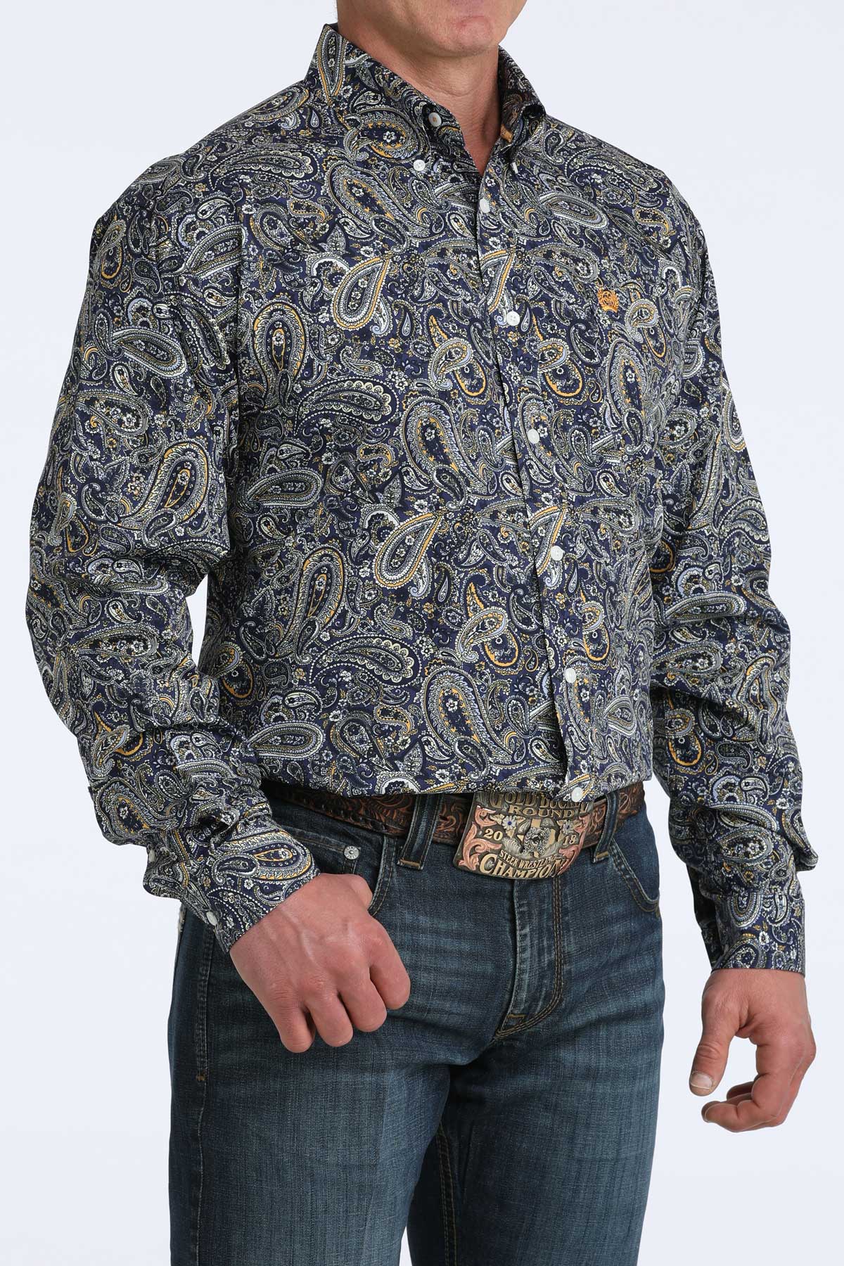 Man wearing a paisley cinch shirt and jeans on a white background