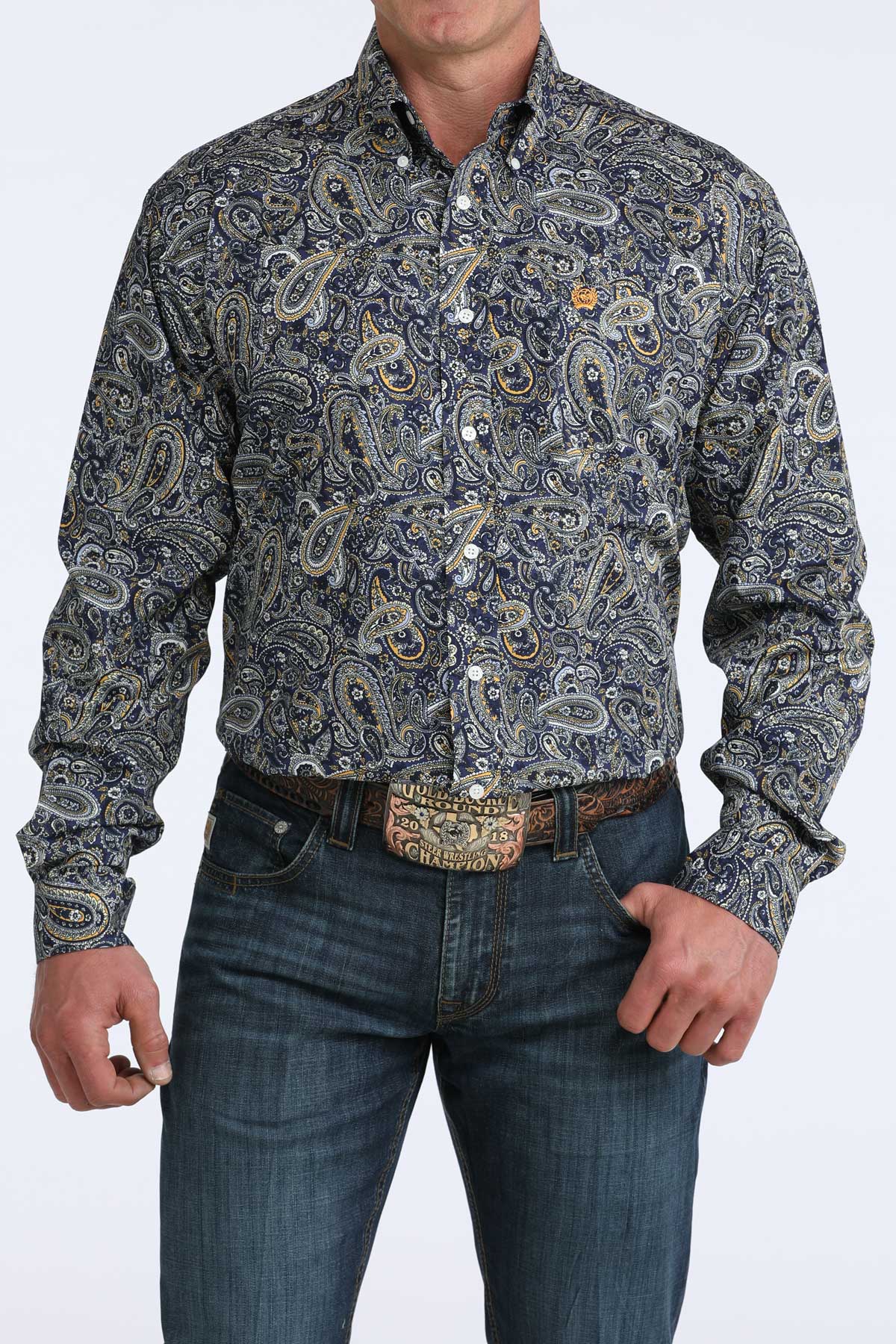 Man wearing a patterned cinch shirt and jeans on a white background