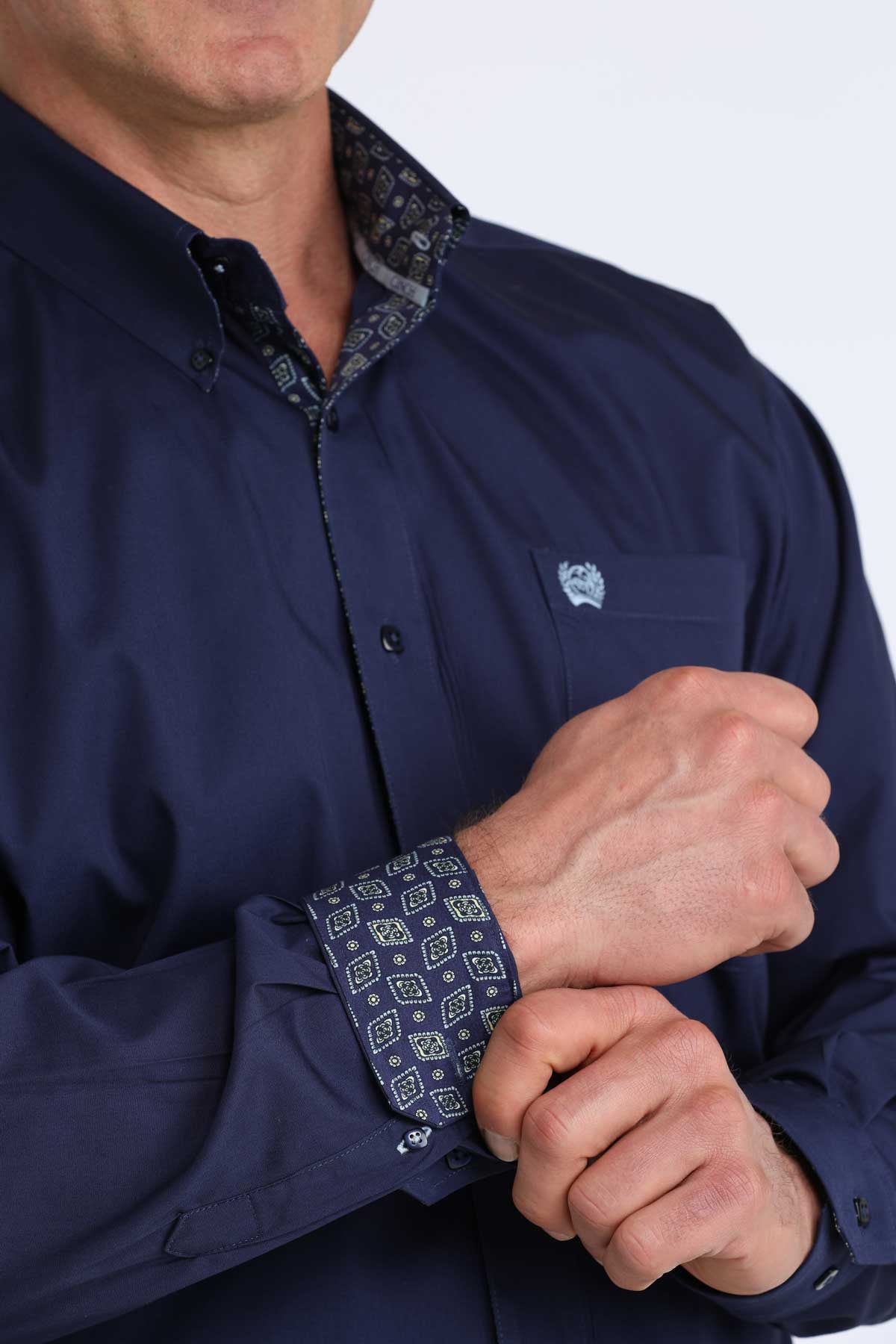 Navy blue cinch shirt with patterned cuffs and collar on a white background