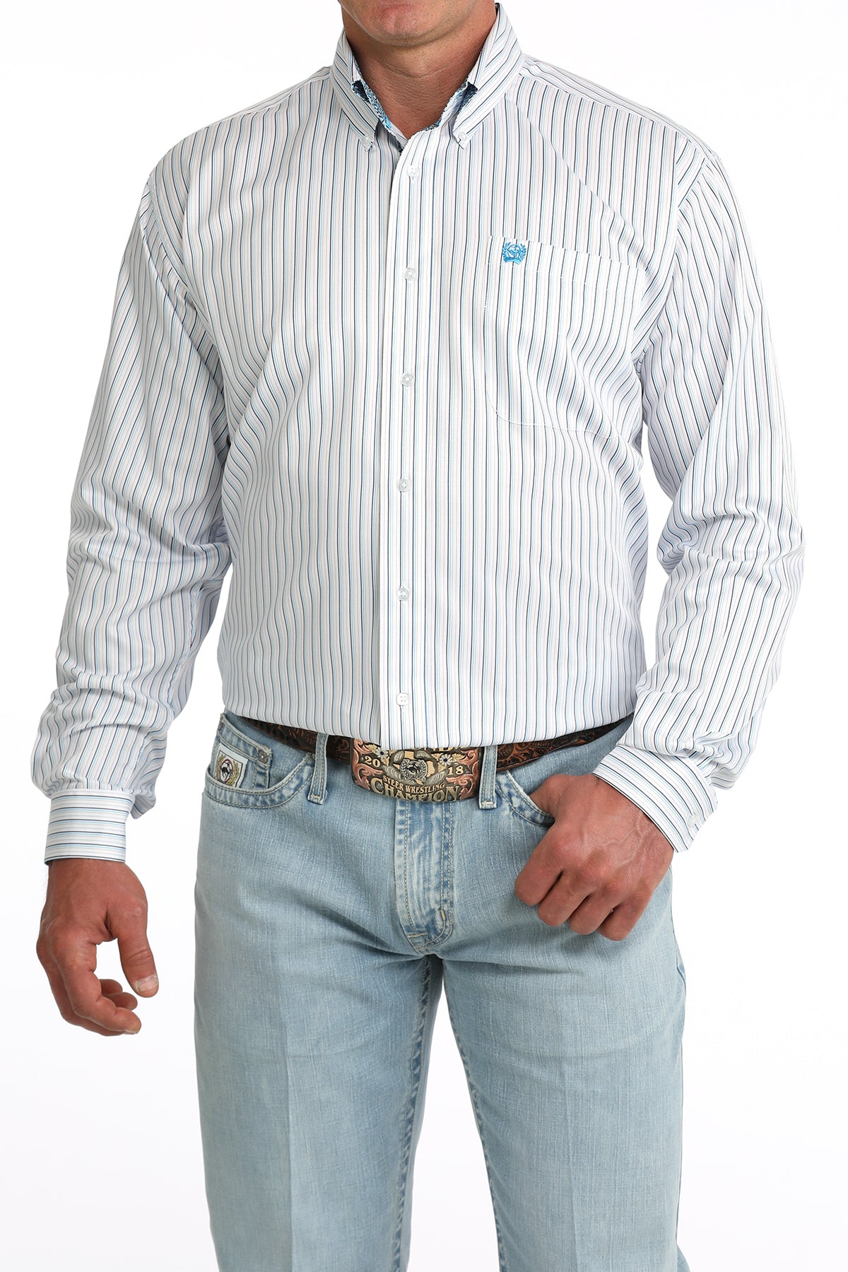 Man wearing a white striped Cinch shirt and light blue jeans with a belt.