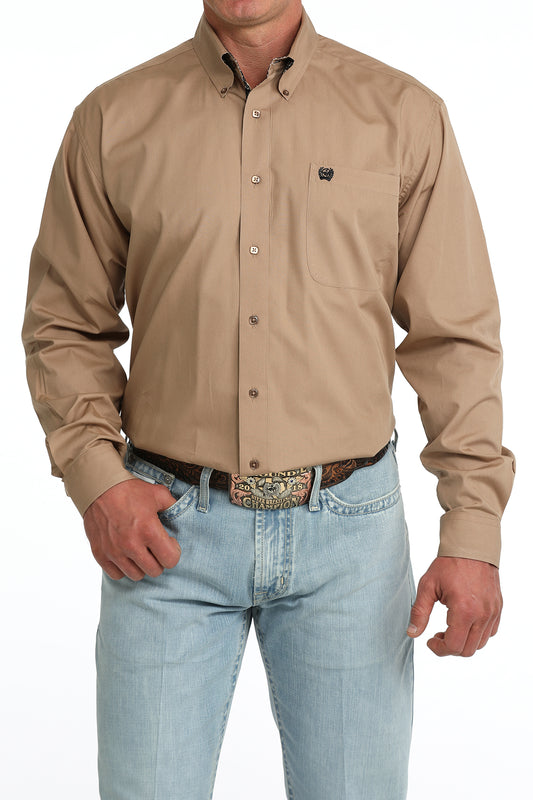 man wearing a brown Cinch shirt and blue jeans on a white background