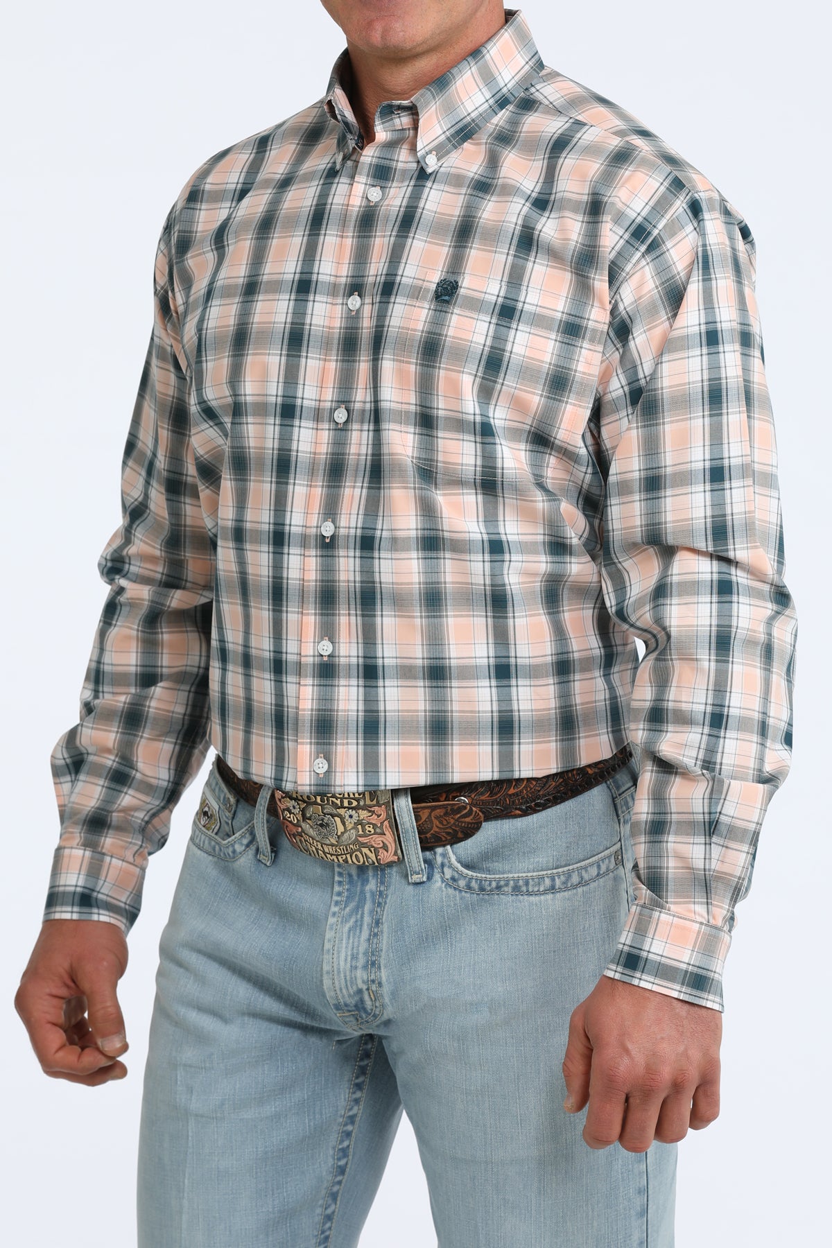 Man wearing a plaid Cinch shirt and jeans on a white background