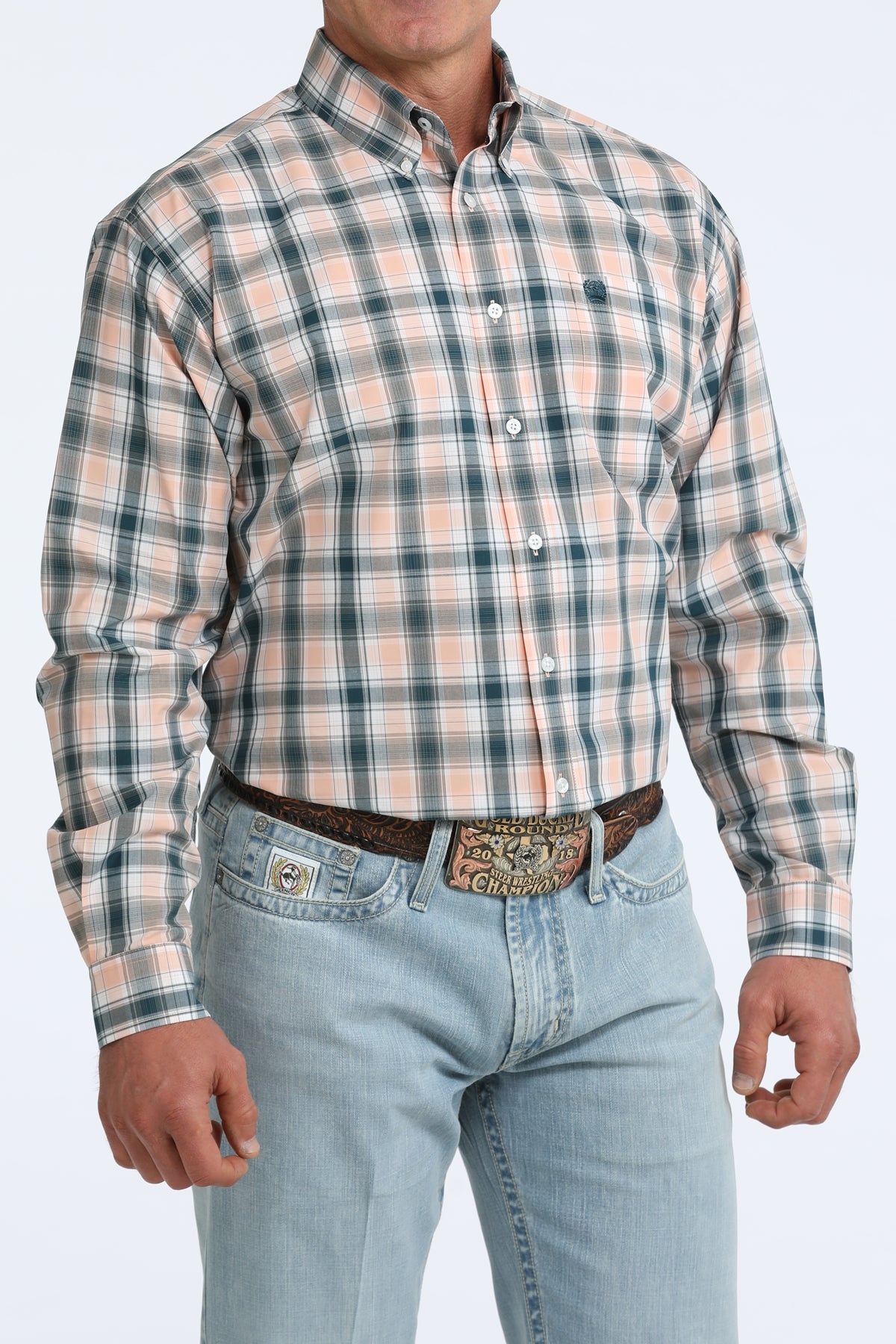 Man wearing a plaid Cinch shirt and jeans on a white background