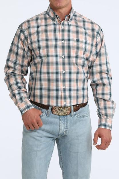 Man wearing a plaid Cinch shirt and jeans on a white background