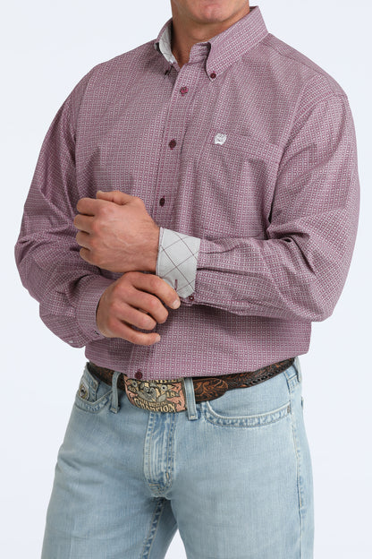 Man wearing a purple checkered Cinch shirt and light blue jeans on a white background