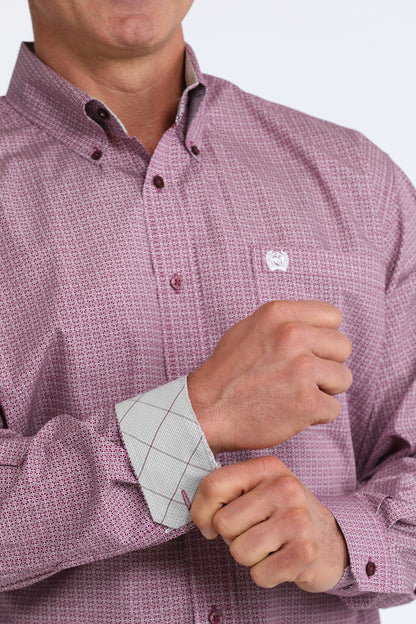 Close-up of a person wearing a pink checkered Cinch shirt with rolled-up sleeves.
