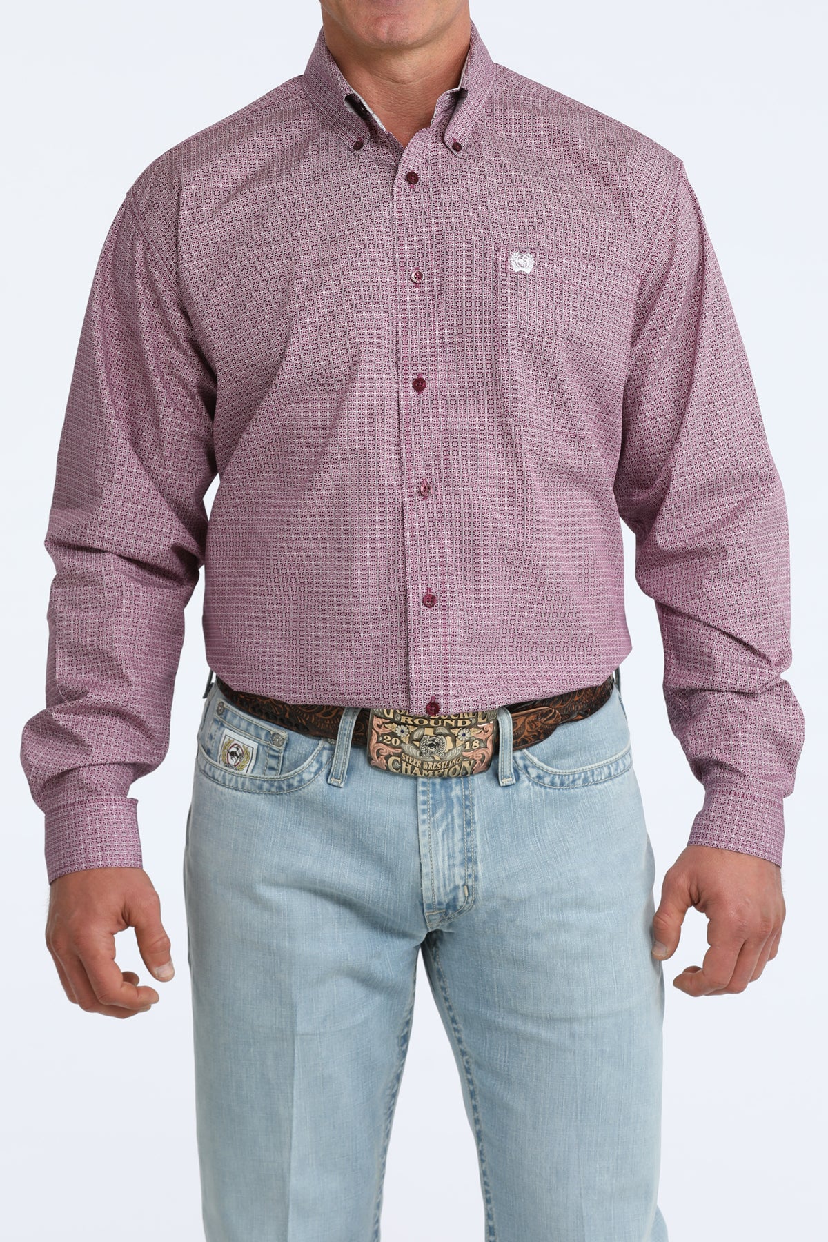 Man wearing a purple checkered Cinch shirt and light blue jeans on a white background