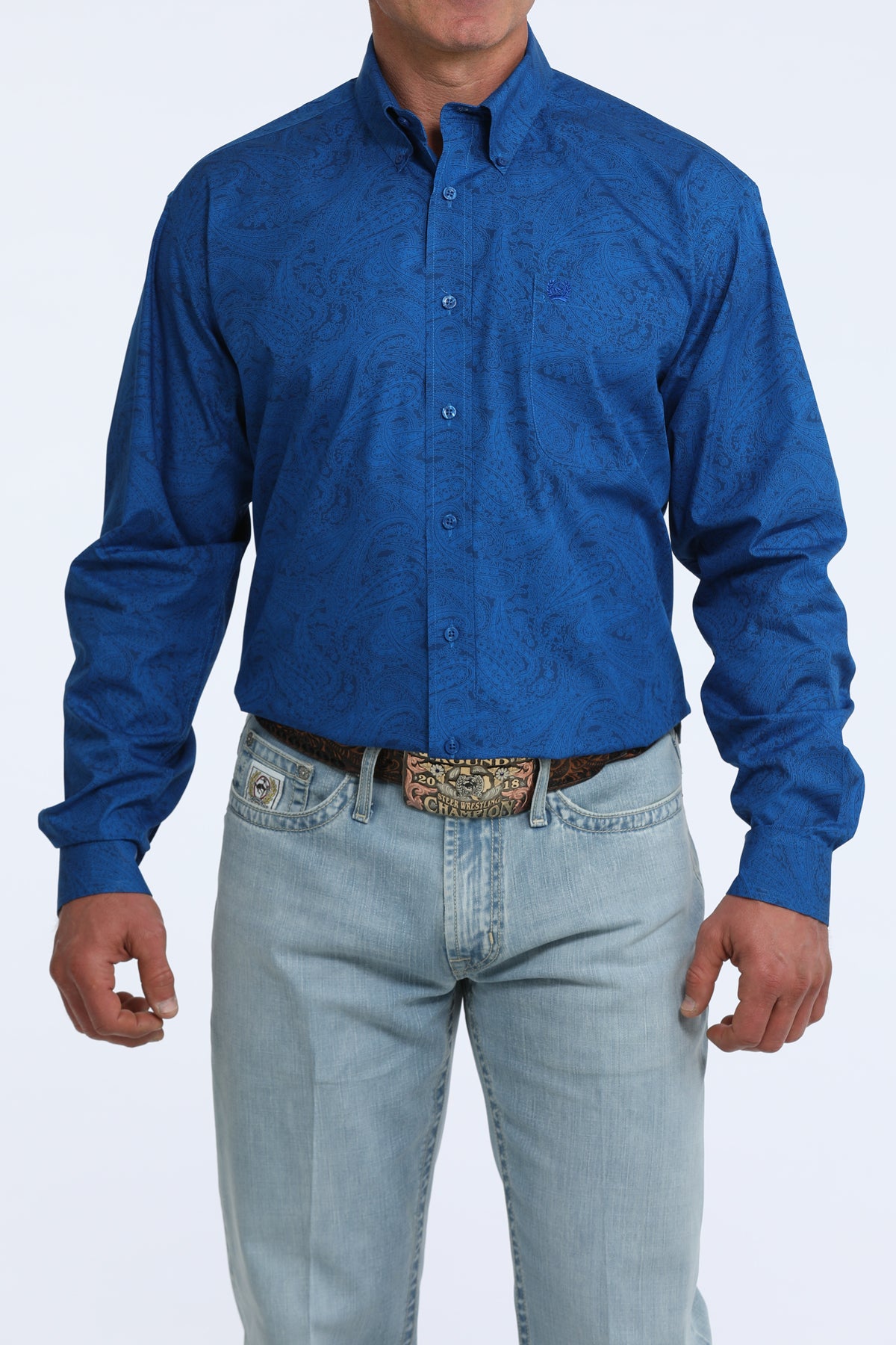 man wearing a blue Cinch shirt and light blue jeans on a white background