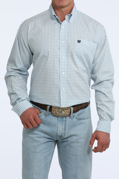 Man wearing a patterned Cinch shirt and jeans on a white background
