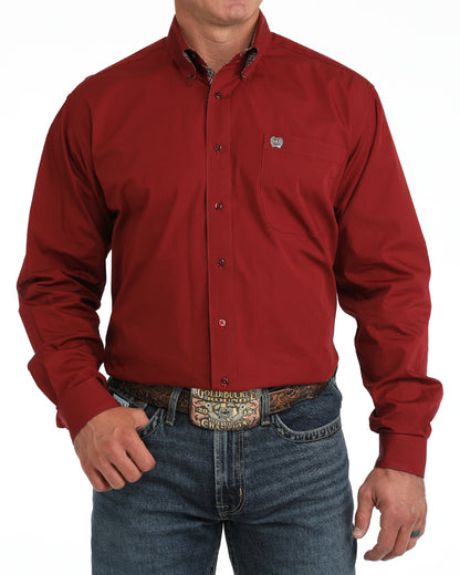 Red button-up Cinch shirt worn by a person on a white background