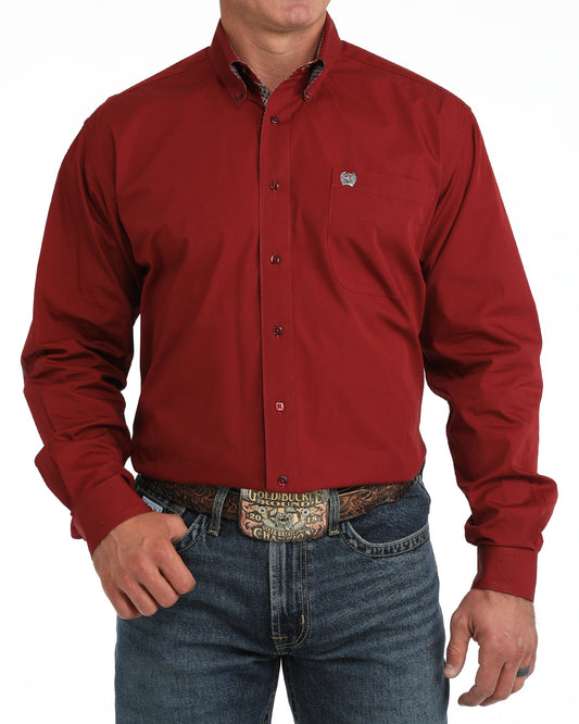 Red button-up Cinch shirt worn by a person on a white background