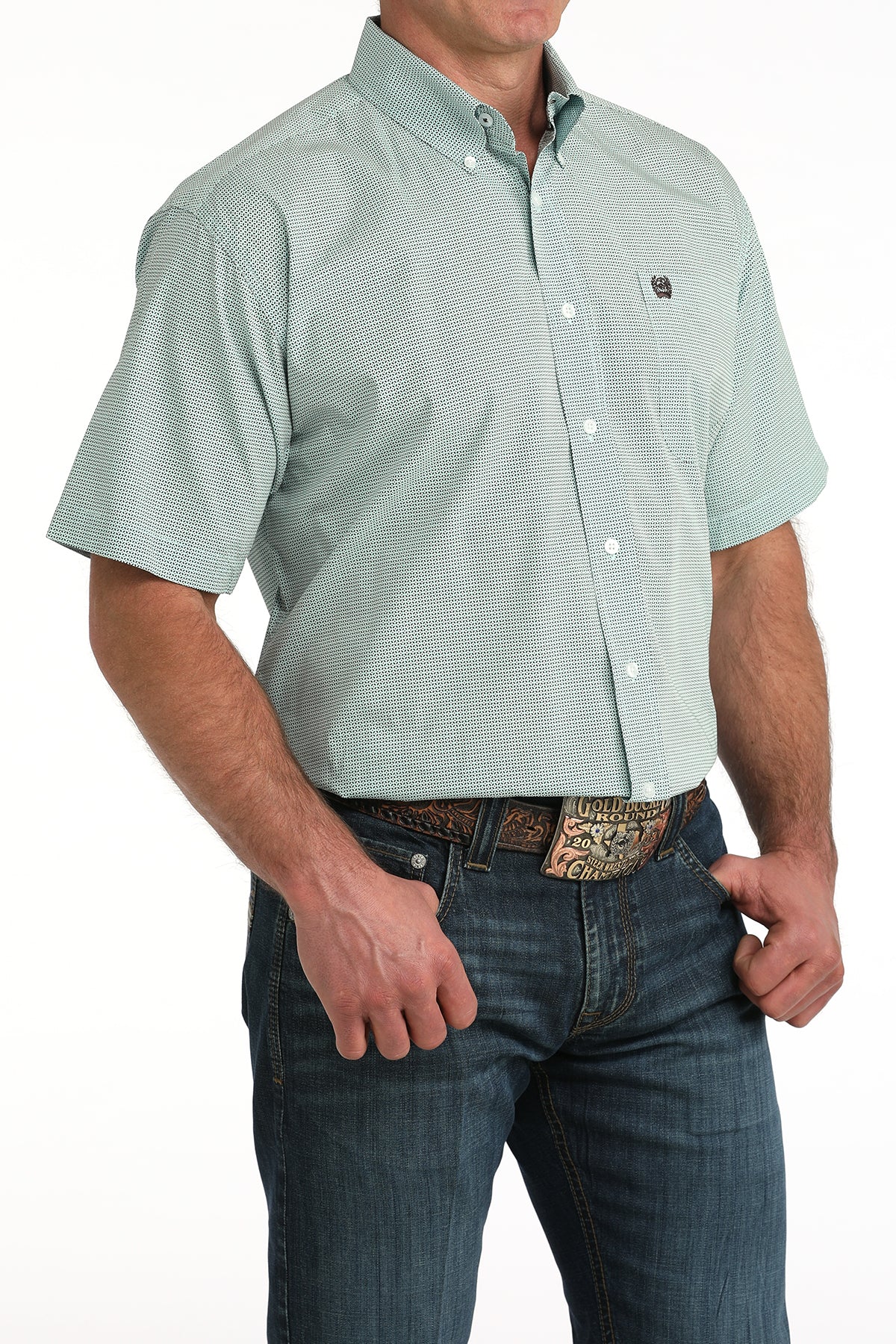 Man wearing a light blue short-sleeve  'Cinch' shirt and blue jeans on a white background