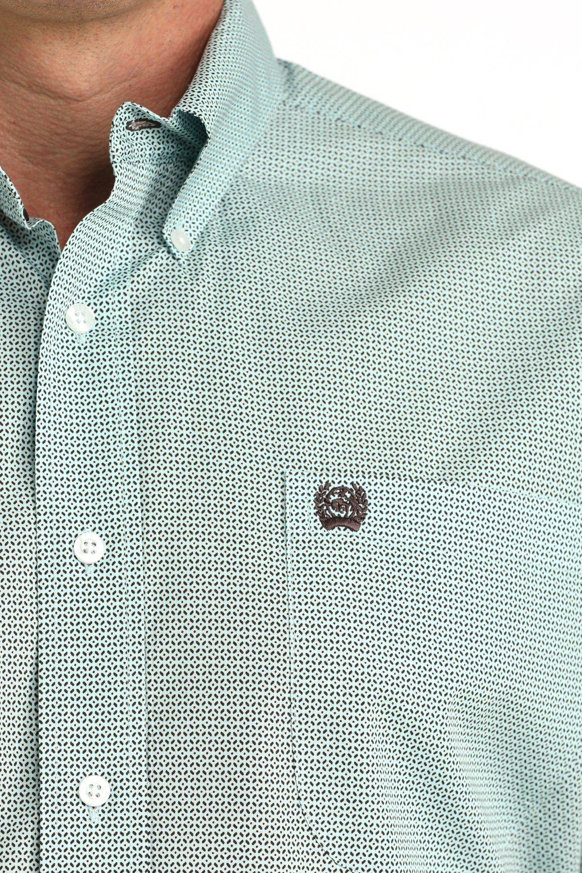 Close-up of a light blue 'Cinch' shirt with a small logo on the chest.