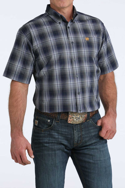 Man wearing a plaid shirt and jeans on a white background