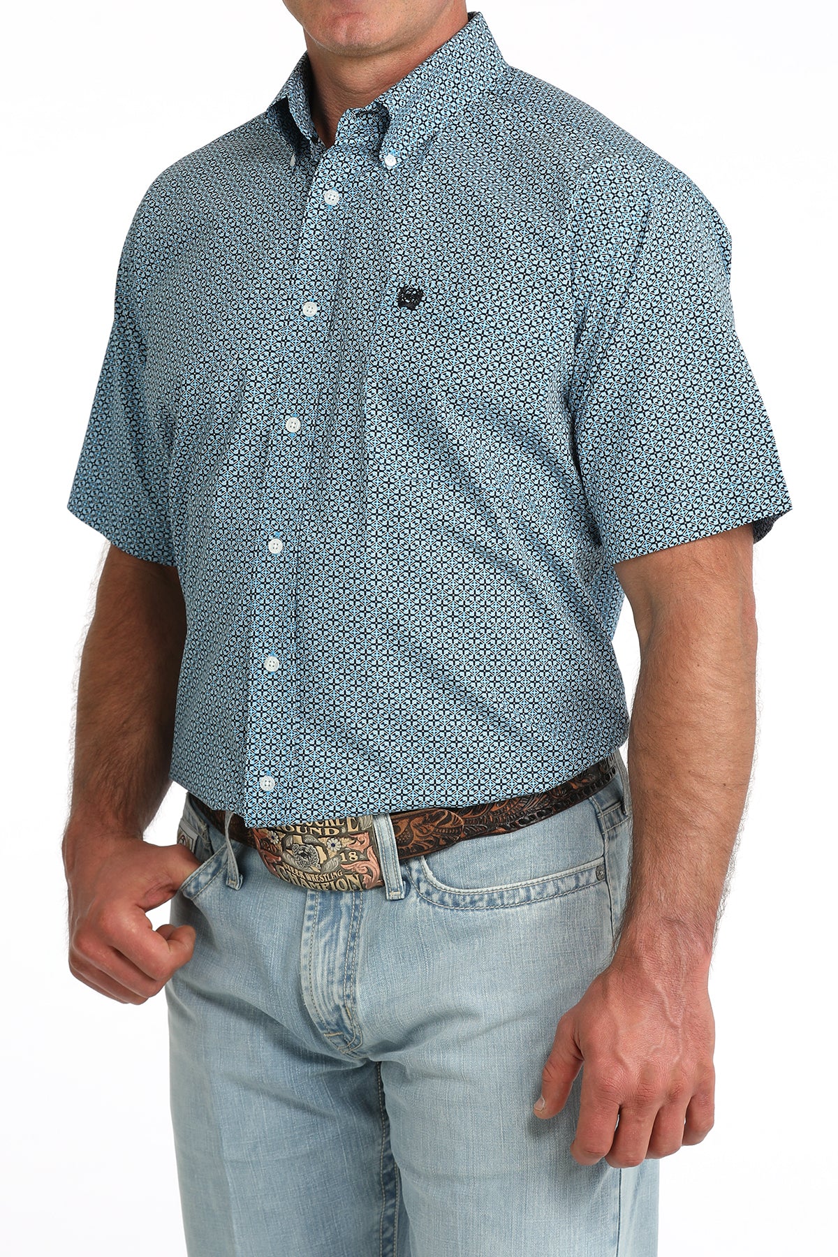 man wearing a blue patterned Cinch shirt with blue jeans on a white background