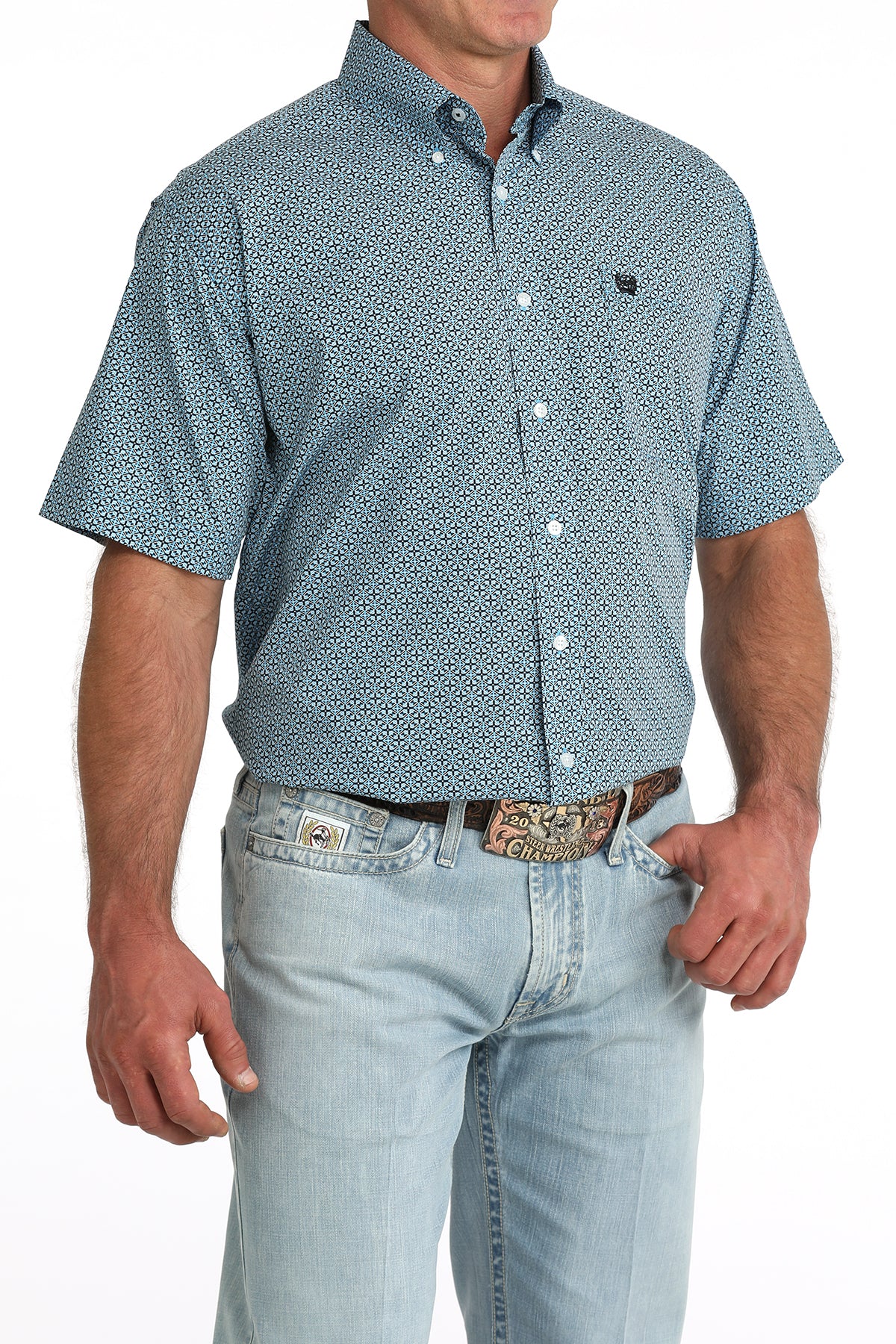 man wearing a blue patterned Cinch shirt with blue jeans on a white background