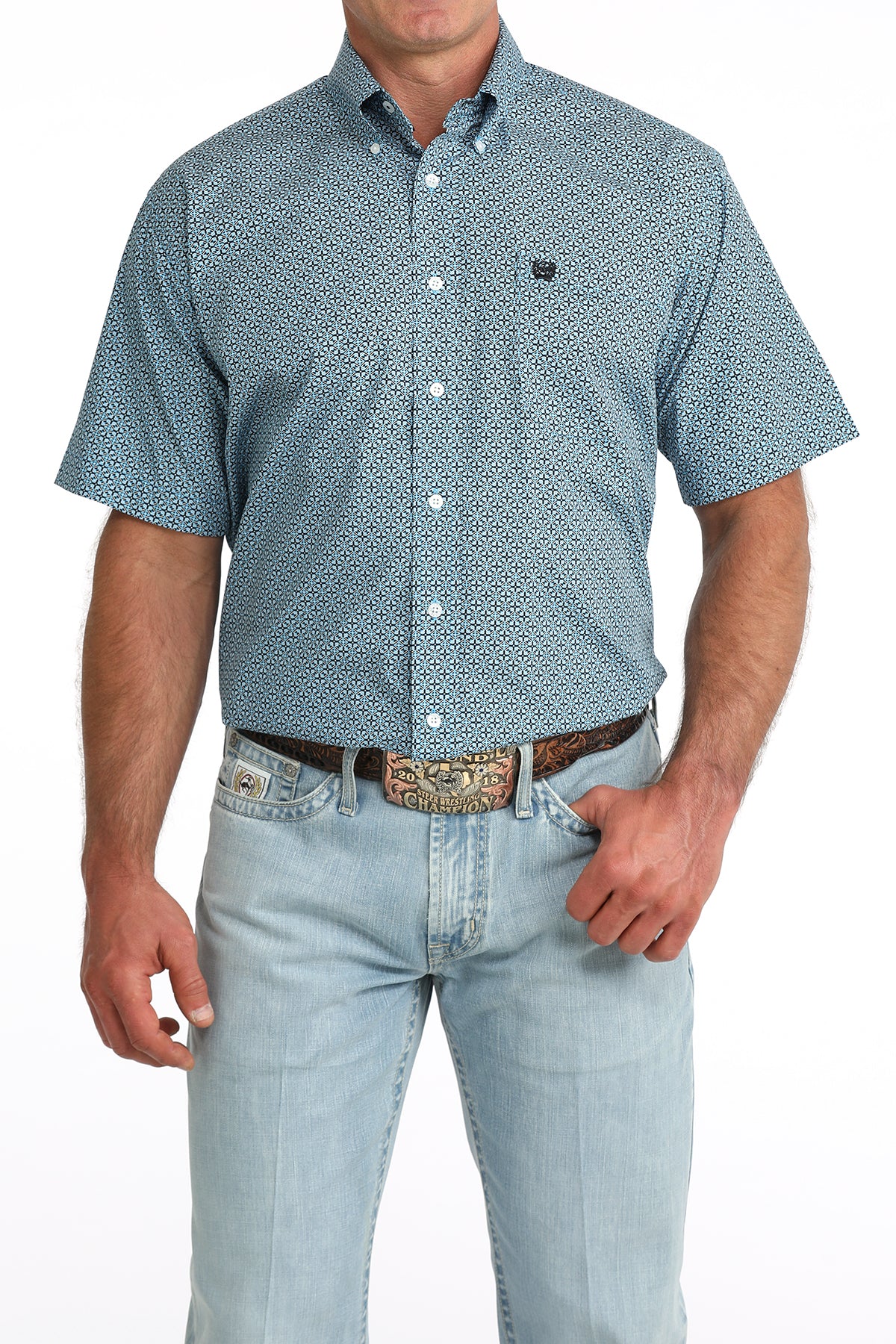 man wearing a blue patterned Cinch shirt with blue jeans on a white background