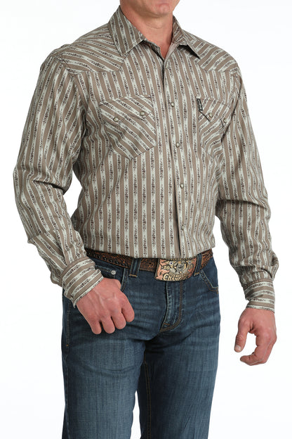 Man wearing a patterned long-sleeve 'Cinch' shirt and jeans on a white background