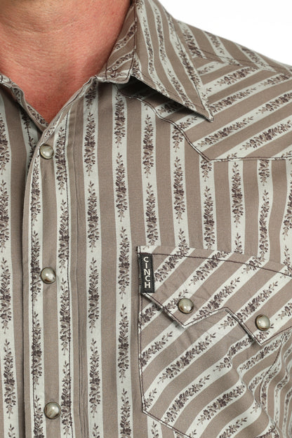 Close-up of a patterned 'Cinch' shirt with a brand logo on a pocket.