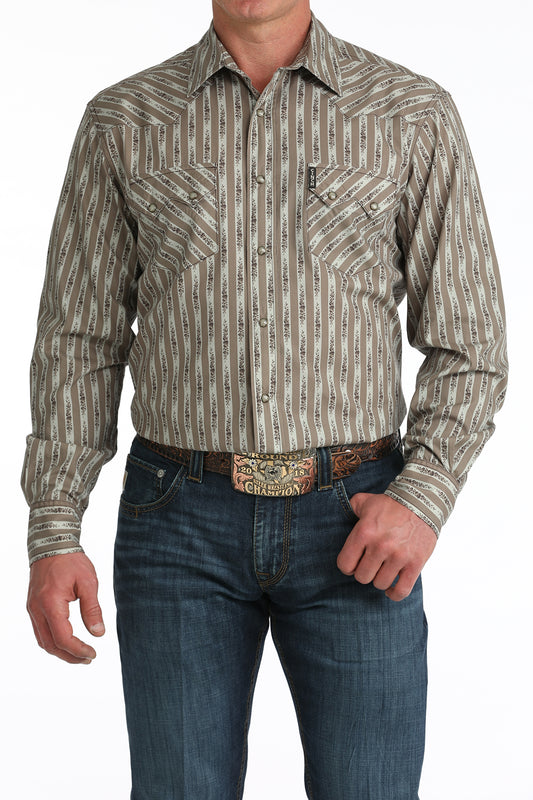 Man wearing a patterned long-sleeve 'Cinch' shirt and jeans with a belt.