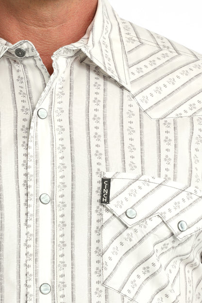 Close-up of a white patterned Cinch shirt with a brand tag visible.