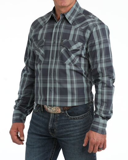 man wearing a blue plaid Cinch shirt and blue jeans on a white background