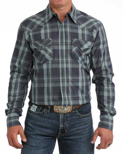 man wearing a blue plaid Cinch shirt and blue jeans on a white background