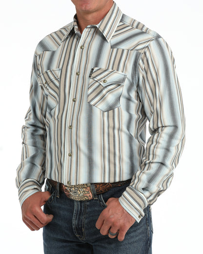 Man wearing a blue striped Cinch shirt and blue jeans on  a white background