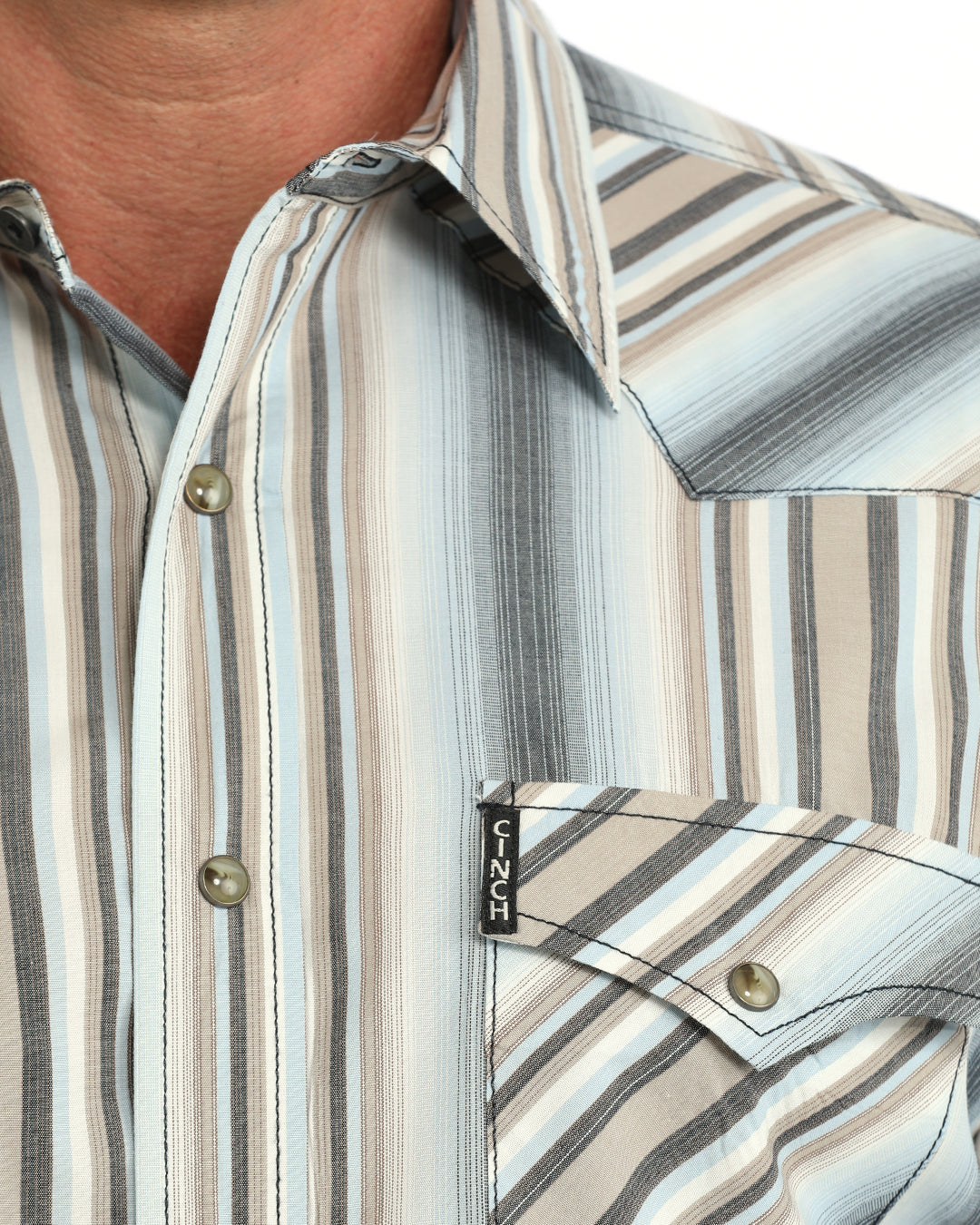 Man wearing a blue striped Cinch shirt on  a white background