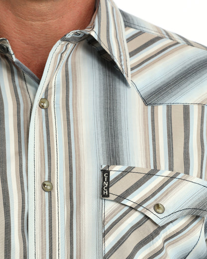 Man wearing a blue striped Cinch shirt on  a white background