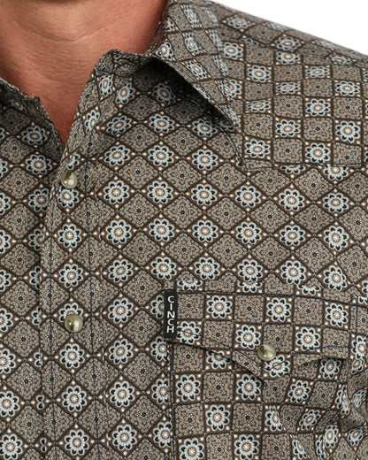Man wearing a brown floral shirt on a white background