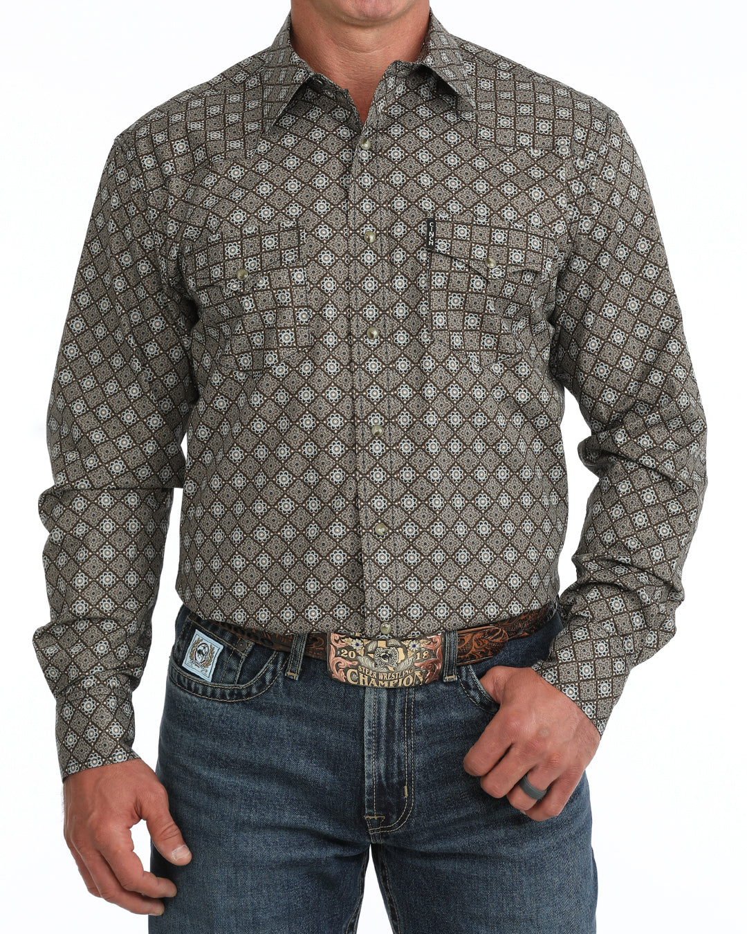 man wearing a brown floal Cinch shirt and blue jeans on a white background