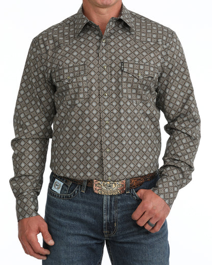 man wearing a brown floal Cinch shirt and blue jeans on a white background