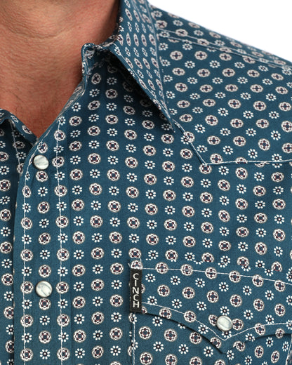 Close up of a man wearing a blue floral Cinch shirt on a white background