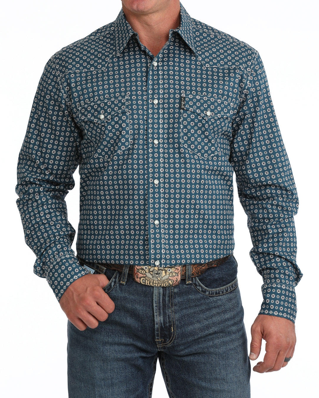 Man wearing a blue floral Cinch shirt and blue jeans on a white background