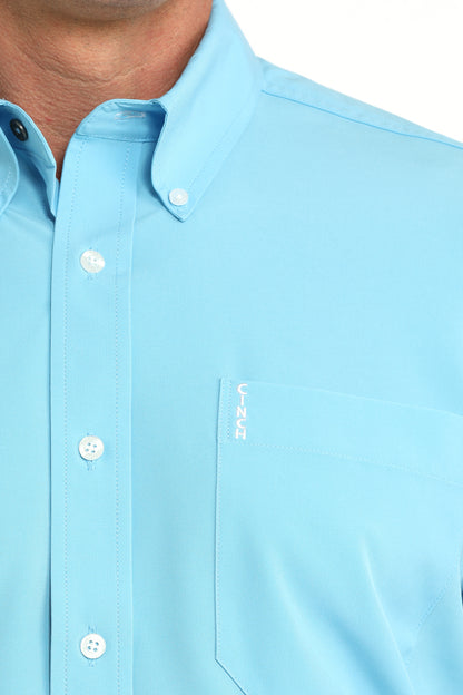 close up of man wearing a blue shirt on a white background